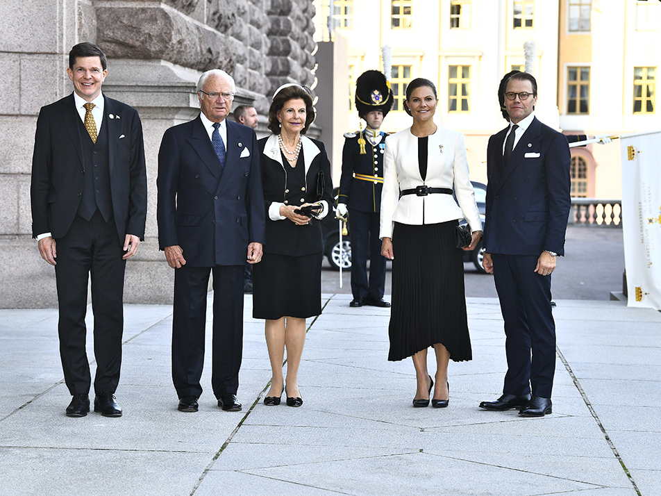 The King and Queen and The Crown Princess Couple are welcomed by the Speaker on the steps of the Riksdag building.